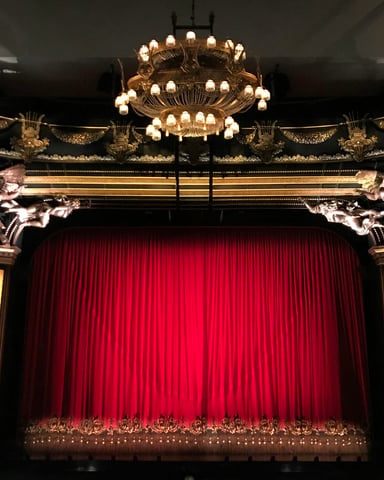Historic Majestic Theatre with ornate proscenium arch and red curtain