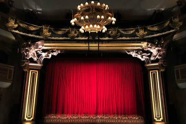 Historic Majestic Theatre with ornate proscenium arch and red curtain