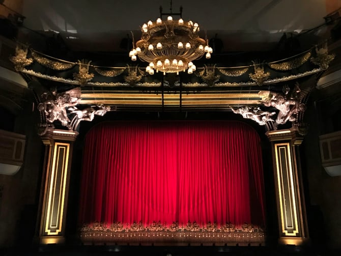 Historic Majestic Theatre with ornate proscenium arch and red curtain