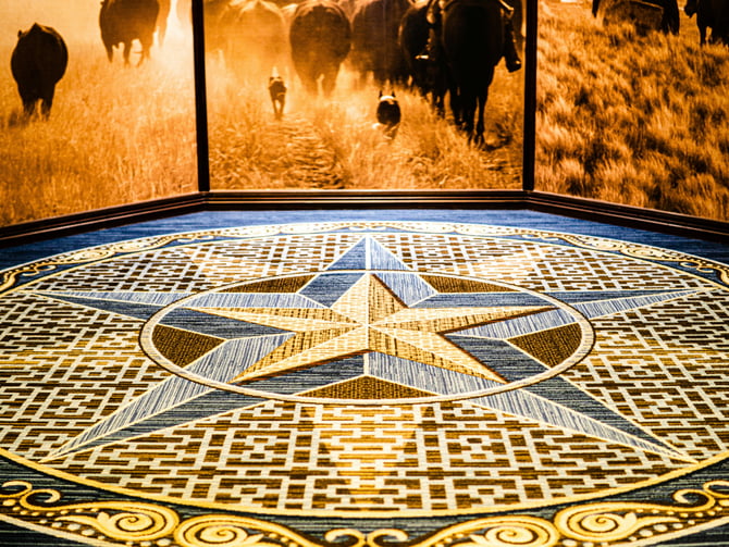 Texas Lone Star mosaic floor with cattle mural backdrop